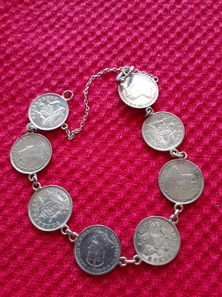 silver bracelet made of Australian coins linked together
